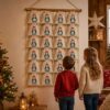 Adventskalender Aus 24 Stoffbeuteln Mit Pinguin Motiv An Einer Wand Aufgehaengt – Liebevolle Weihnachtsdekoration Fuer Kinderzimmer Und Wohnzimmer